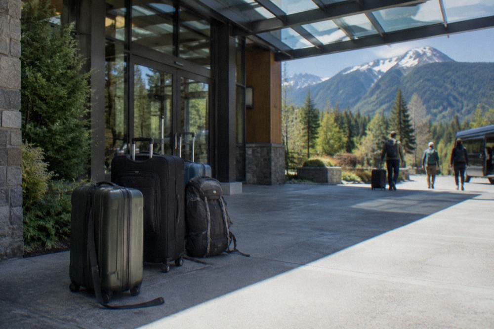 A quiet hotel entrance awning on a Seattle morning with bags by the door